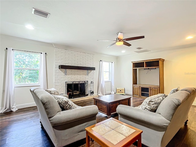 living room with ceiling fan, dark wood-type flooring, and a brick fireplace