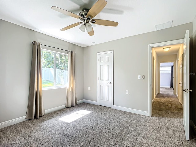 unfurnished bedroom featuring ceiling fan and carpet