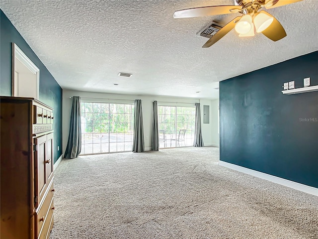 carpeted spare room with ceiling fan and a textured ceiling