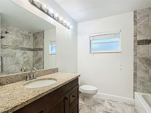 bathroom with vanity, toilet, and a textured ceiling