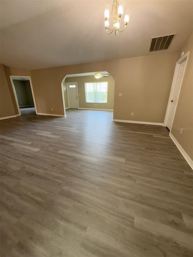 unfurnished room with dark hardwood / wood-style floors and a chandelier