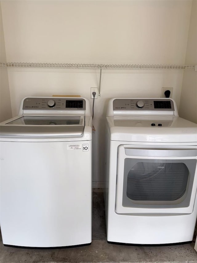 laundry area with washing machine and dryer