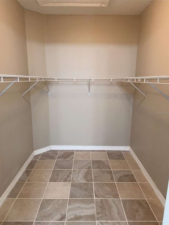 walk in closet featuring tile patterned flooring