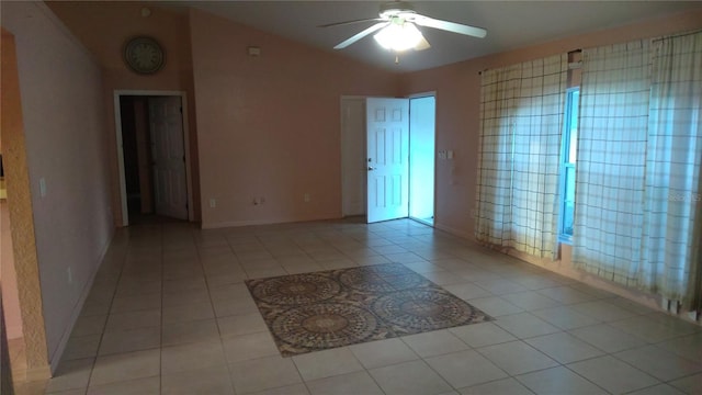 tiled empty room featuring ceiling fan