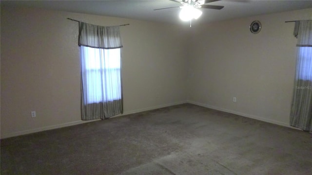 carpeted spare room with ceiling fan