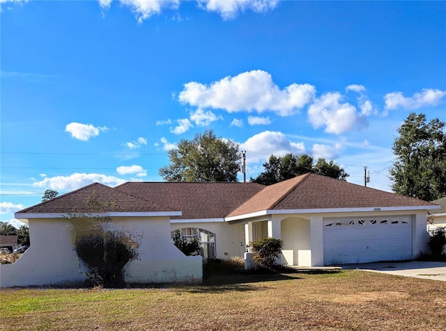 ranch-style home with a garage and a front lawn