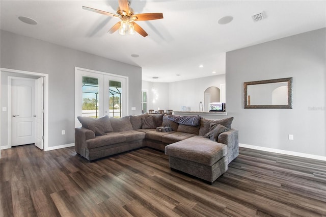 living room with french doors, dark hardwood / wood-style floors, and ceiling fan