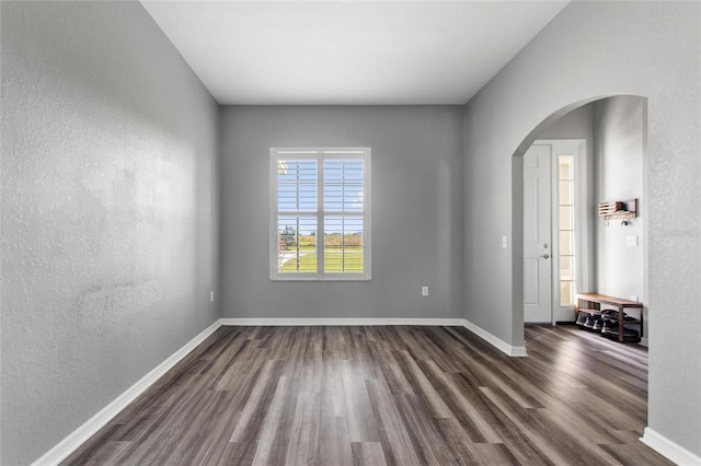 empty room with dark hardwood / wood-style floors