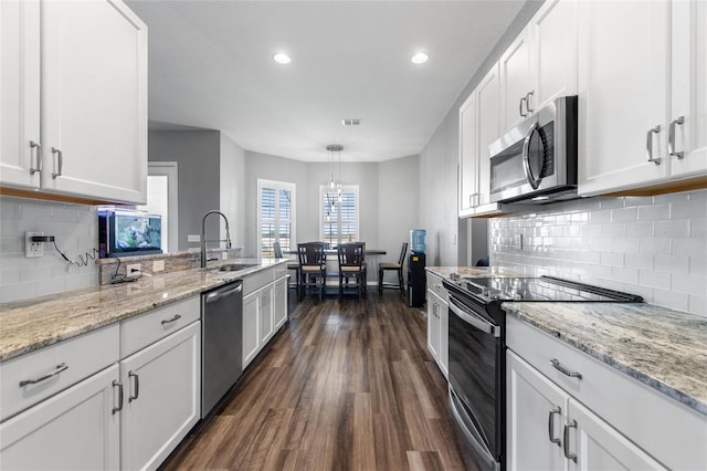 kitchen with sink, appliances with stainless steel finishes, and white cabinets