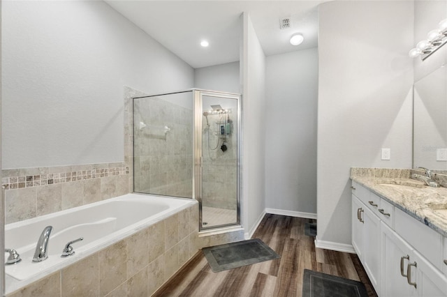 bathroom with vanity, shower with separate bathtub, and wood-type flooring