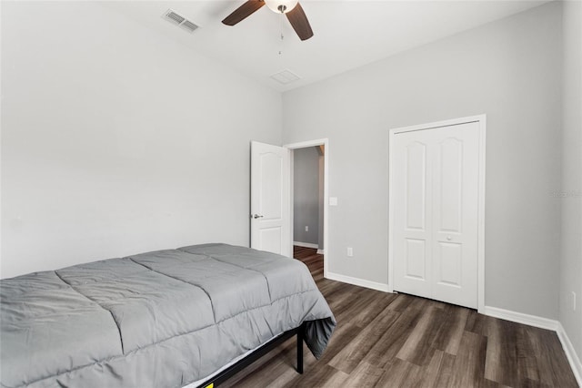 bedroom with dark hardwood / wood-style flooring, a closet, and ceiling fan