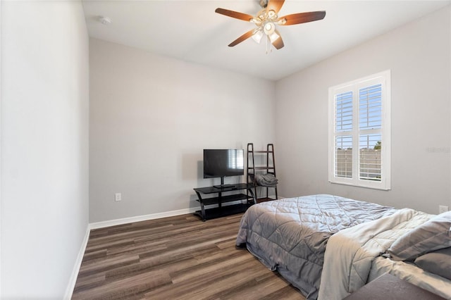 bedroom with dark hardwood / wood-style floors and ceiling fan