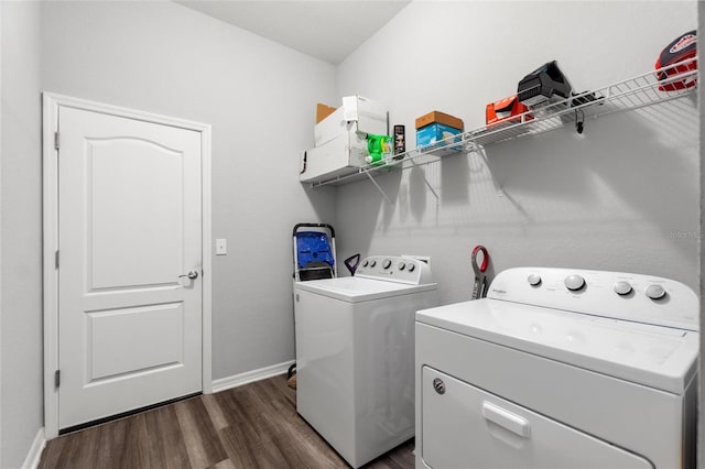 clothes washing area with dark wood-type flooring and washing machine and dryer