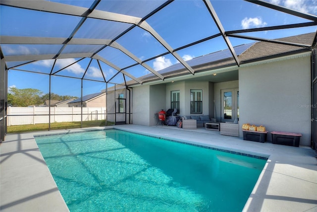 view of swimming pool featuring a patio area, an outdoor living space, and glass enclosure