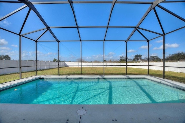 view of pool with glass enclosure