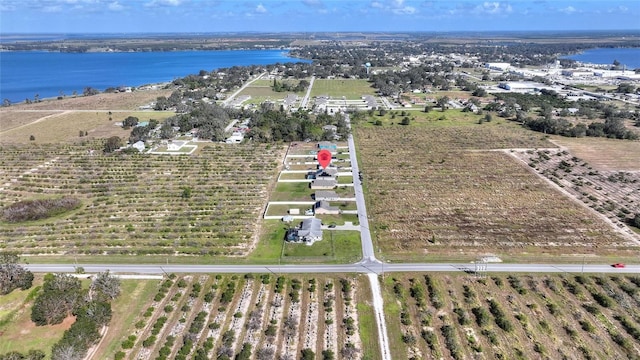 birds eye view of property with a water view and a rural view