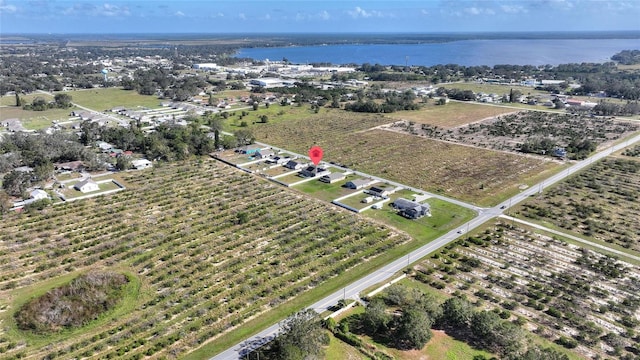 birds eye view of property featuring a water view and a rural view