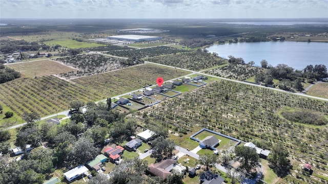 birds eye view of property with a water view and a rural view