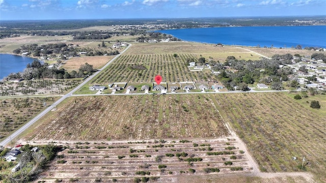 drone / aerial view featuring a water view and a rural view