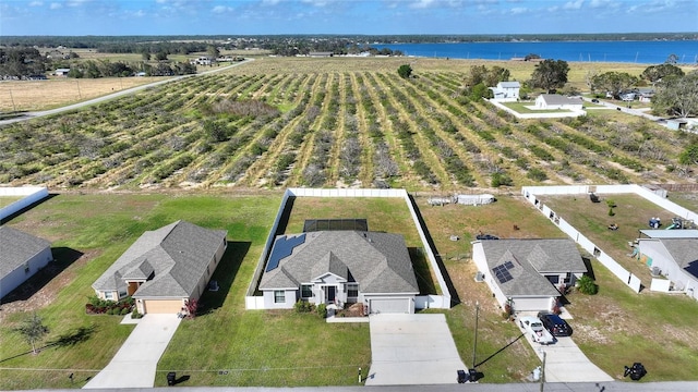 birds eye view of property with a water view and a rural view