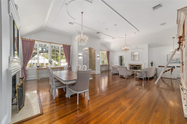 dining space featuring vaulted ceiling and dark hardwood / wood-style floors