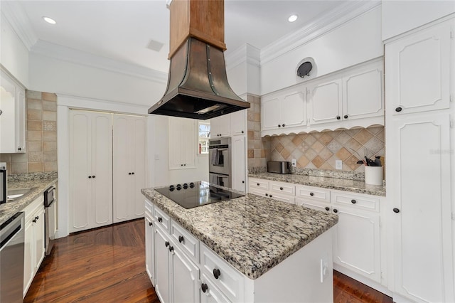 kitchen featuring white cabinetry, appliances with stainless steel finishes, a center island, and dark hardwood / wood-style flooring