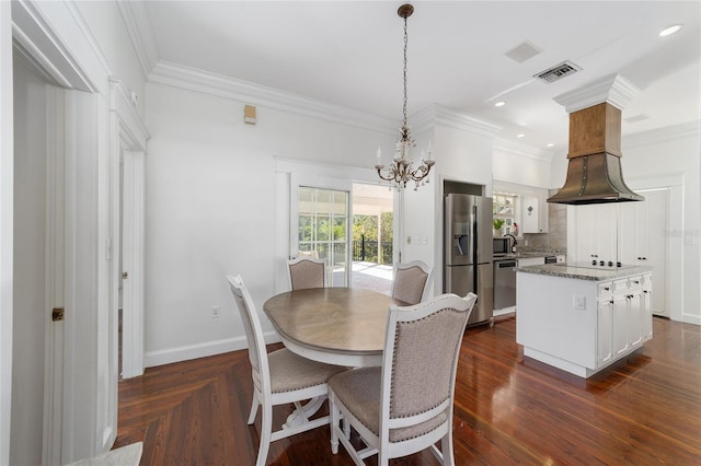 dining area with ornamental molding, dark hardwood / wood-style flooring, and a chandelier