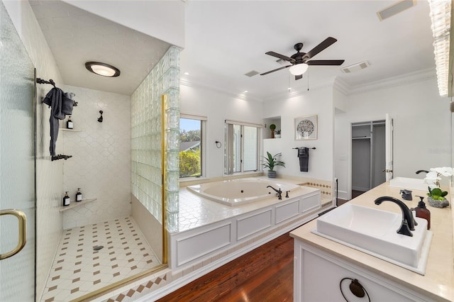 bathroom featuring wood-type flooring, ornamental molding, walk in shower, vanity, and ceiling fan