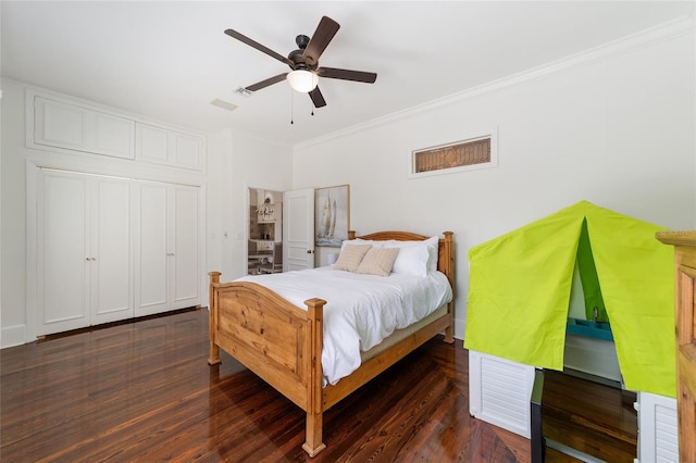 bedroom featuring ornamental molding, dark wood-type flooring, and ceiling fan