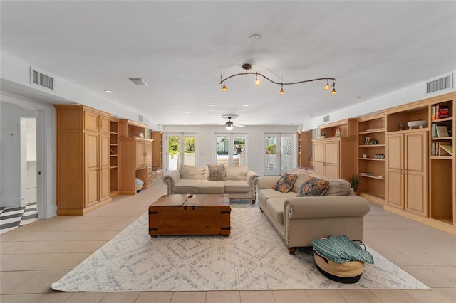 living room featuring french doors and light tile patterned floors