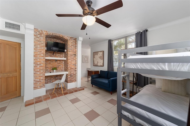 tiled bedroom with ornamental molding and ceiling fan