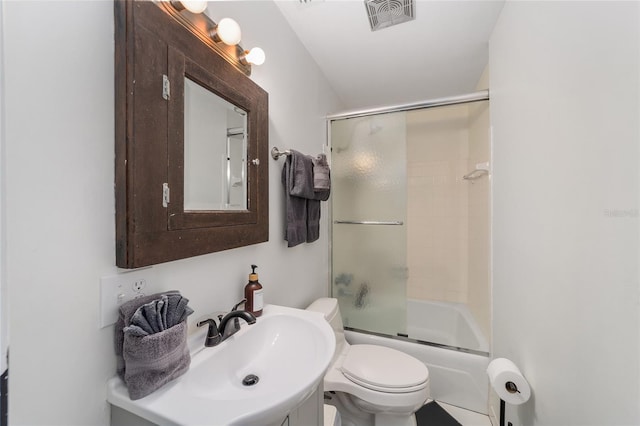 full bathroom featuring toilet, bath / shower combo with glass door, vanity, and tile patterned floors