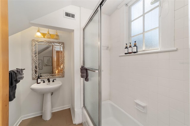 bathroom featuring tile patterned floors and enclosed tub / shower combo