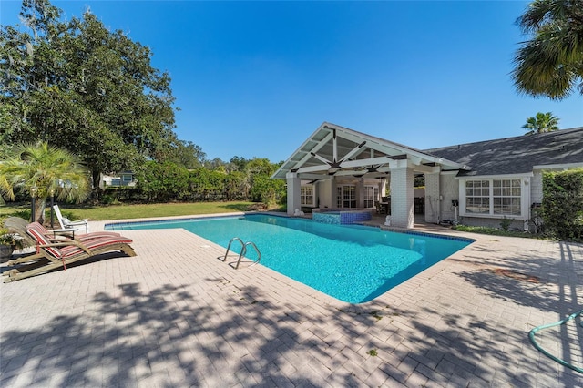 view of swimming pool featuring a patio and ceiling fan