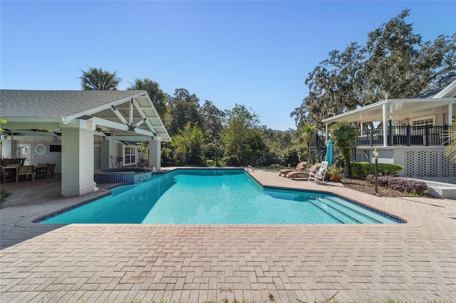 view of pool with a patio and ceiling fan