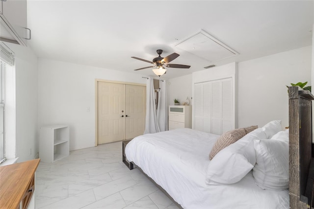 bedroom with two closets and ceiling fan