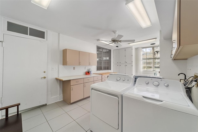 laundry room featuring ceiling fan, washing machine and dryer, light tile patterned flooring, and cabinets