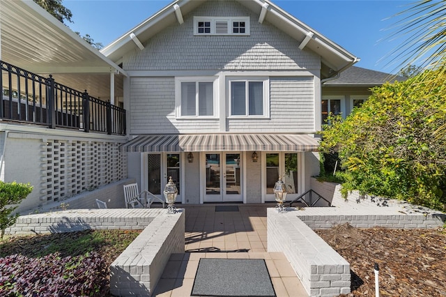 rear view of property with a patio area and a balcony