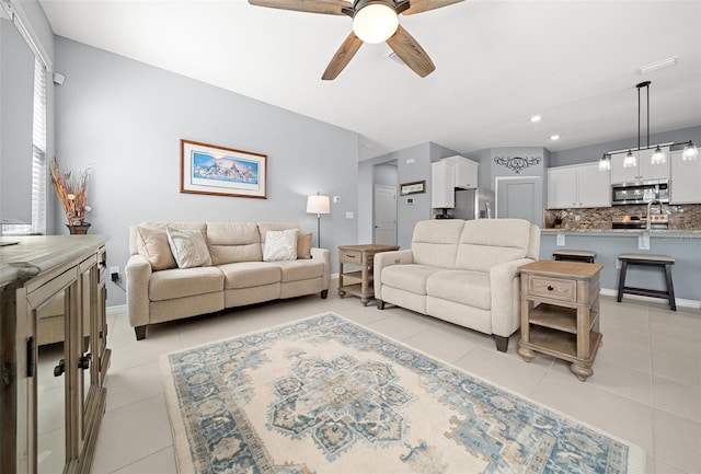 living room featuring light tile patterned floors and ceiling fan