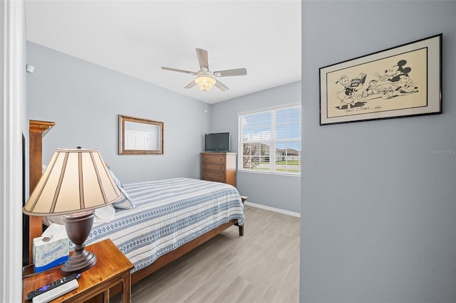 bedroom with light hardwood / wood-style flooring and ceiling fan