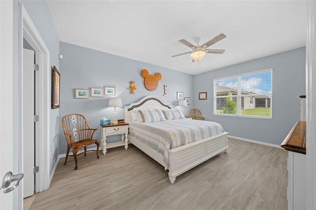 bedroom with ceiling fan and light hardwood / wood-style floors