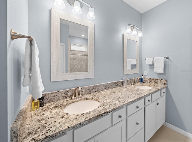 bathroom with tile patterned floors and vanity