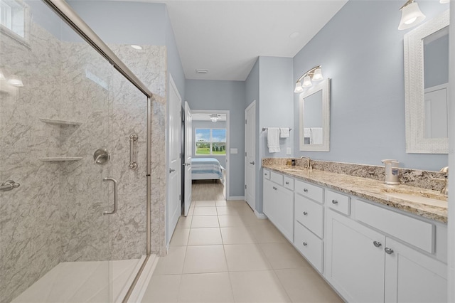 bathroom featuring tile patterned floors, vanity, and a shower with shower door