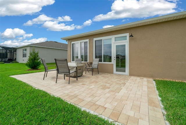 back of property featuring a lawn and a patio area