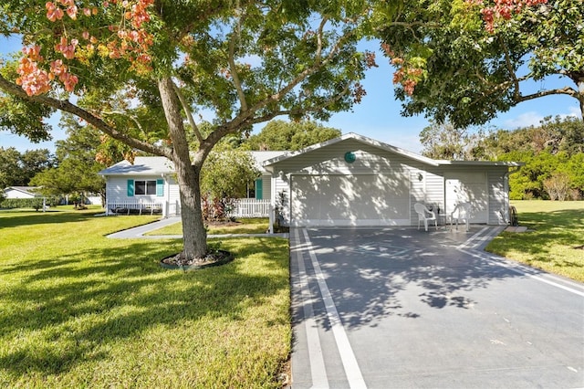 ranch-style home featuring a front lawn and a garage