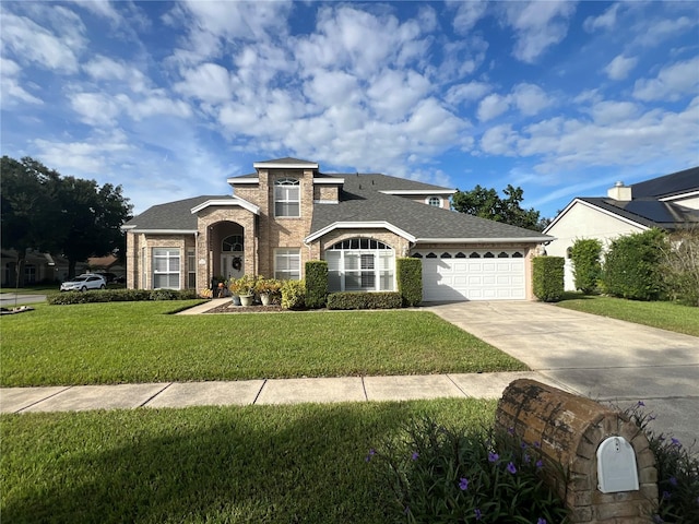 view of front of house featuring roof with shingles, brick siding, an attached garage, driveway, and a front lawn