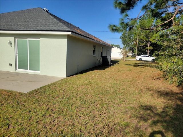 view of yard with central air condition unit and a patio area