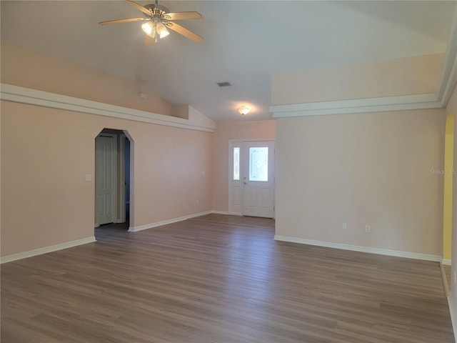 unfurnished room featuring vaulted ceiling, dark hardwood / wood-style flooring, and ceiling fan