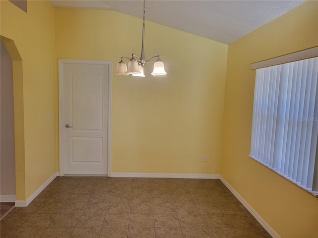 unfurnished dining area featuring a chandelier and vaulted ceiling