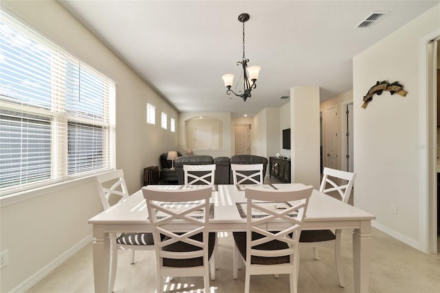 dining space featuring a notable chandelier